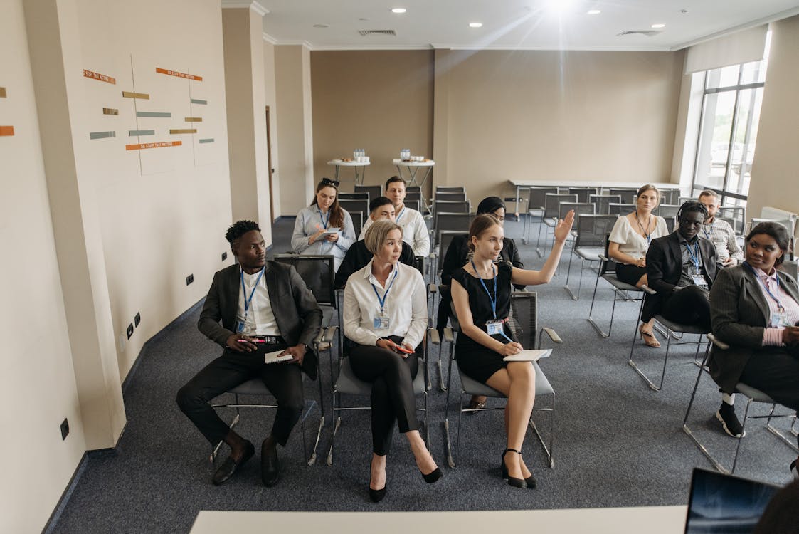 A group of diverse adults attending a business meeting in a modern conference room