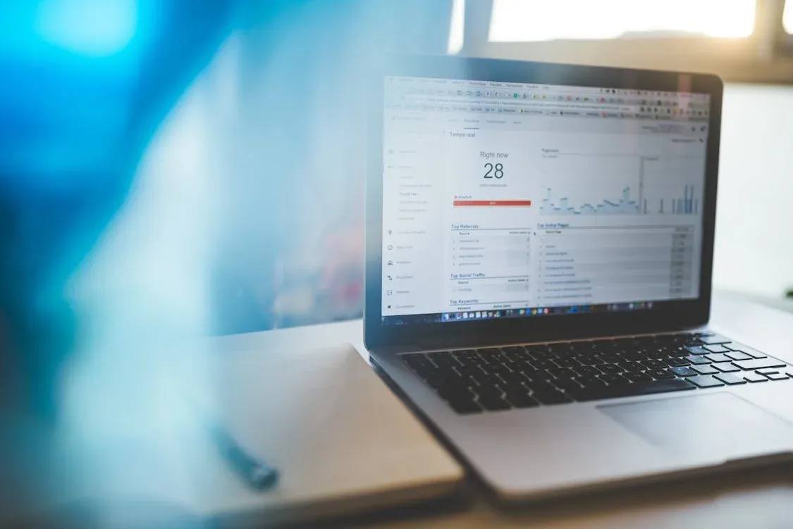 Laptop displaying Google Analytics in a modern workspace, highlighting digital analytics and technology
