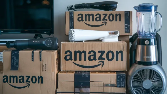 A stack of various products, including electronics, books, and beauty items, with the Amazon logo prominently displayed