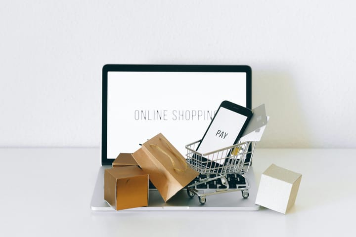 Display of online shopping theme with mini cart and payment devices on laptop. 